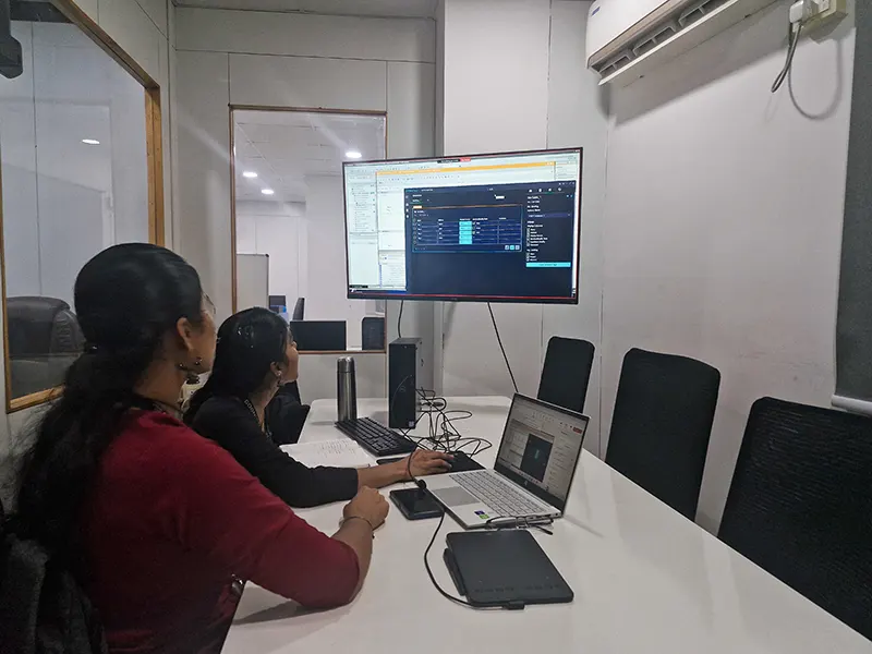 Two girls engage in hands-on learning with industrial automation software, gaining practical skills for real-world applications in PLC and SCADA systems.